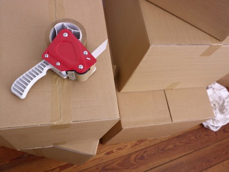Boxes and furniture arranged in a new home after removals in Elmpark